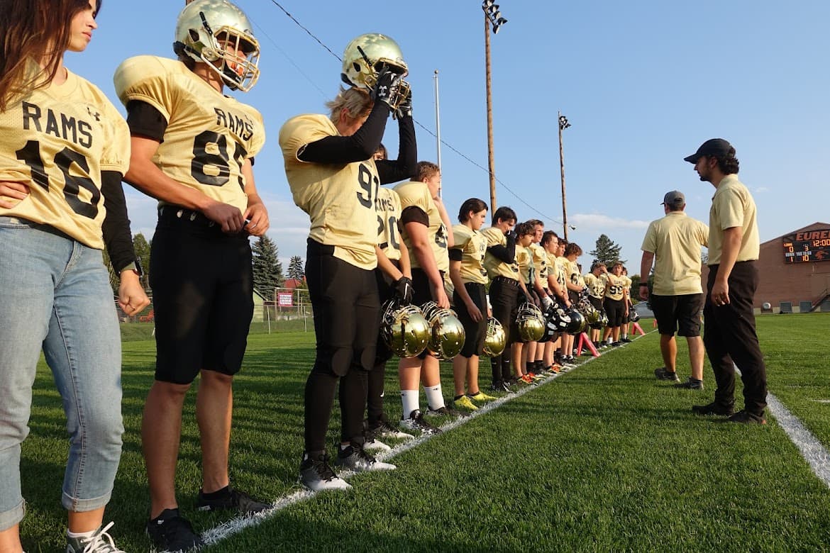 Rocky Mountain Rams football players lined up on the sideline